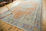 Distressed blush rose peach and antique ivory Oushak texture with pale royal blue.