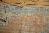 Vintage Distressed Oushak carpet with blush rose, ivory, and pale blue border patterns.