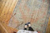 Textured pile of a vintage Distressed Oushak carpet in blush peach and pale blue.