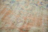 Distressed Oushak carpet pile revealing even wear to knot heads and soft blush, ivory, and blue hues.