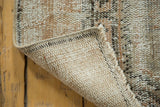 Detail of distressed vintage Oushak runner showing worn pile texture, secured side, and neutral foundation.