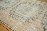 Vintage Oushak runner's distressed surface, showing exposed knot heads, blush rose, and ivory hues.