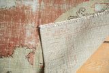 Visible hand-knotted foundation, fringed edge, and even wear on a vintage distressed Turkish Oushak runner.