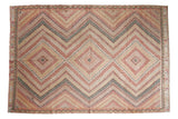 Vintage hand-woven Turkish Jijim carpet with triple concentric diamond medallions in red, ivory, green.