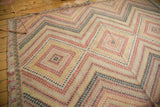 Dynamic stepped diamond pattern with varied color fills on a vintage Jijim.