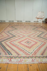 Close-up of the hand woven Turkish Jijim rug's stepped border in red, ivory, and forest green.