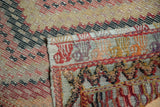 Hand-woven vintage Jijim carpet showing flatweave texture and multicolored decorative selvedge.