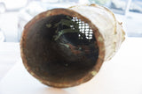The hollow interior of the vintage Benin bronze head showing its coarse, aged patina.