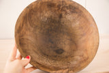 Close-up of the vintage African wood bowl's interior, showing deep cracks and aged patina.