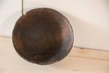 Hand-carved vintage African bowl with dark wood, showing rustic texture, visible cracks, and imperfections.