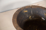 Vintage African bowl detail shows cracks, dark wood, and aged metal plate repairs.