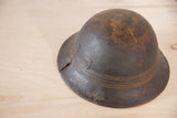 Dark hand-carved African bowl displaying notable crack, primitive metal repairs, and carved lines.