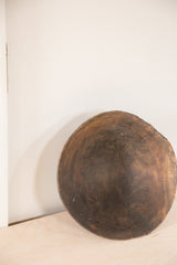Vintage wooden African bowl, highlighting natural wood grain and visible imperfections near the base.
