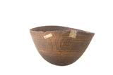 Vintage hand-carved African wooden bowl, dark with etched lines, cracks, and metal repairs.