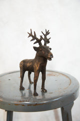 Detailed antlers and mottled copper texture on the vintage African elk sculpture.