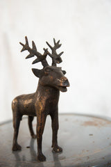 Close view of the vintage African copper elk sculpture's legs with textured patina.