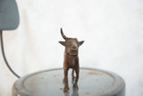Detailed copper face and horns of the vintage African wildebeest sculpture.