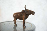 Vintage copper African wildebeest sculpture showcasing its textured body and detailed face.