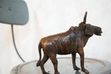 Textured copper finish of the vintage African wildebeest sculpture's back and legs.