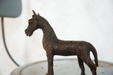 Vintage African copper zebra sculpture with dark patina and carved body stripes.