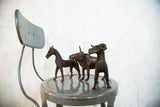 Detailed vintage copper African zebra sculpture with two stylized animal figures.