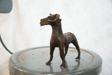 Detailed head and textured body of a vintage copper African ram sculpture.