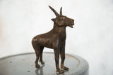 Vintage African copper topi, close-up of its detailed face and aged patina.