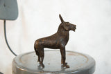 Copper African topi sculpture in profile, highlighting the textured patina.