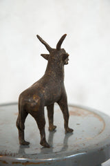 Detailed rear view of the vintage African topi sculpture with aged copper patina.