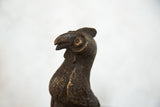 Close-up of the vintage African bird sculpture's detailed copper texture and head.