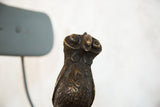 Detailed head, textured body, and patinated copper of the vintage African bird.