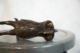 Vintage African bird sculpture with intricate embossed patterns and aged copper patina.