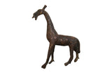 Vintage African giraffe sculpture in copper with a dark patina and detailed circular pattern.