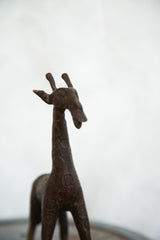 Stylized head and textured neck of the vintage copper giraffe sculpture.