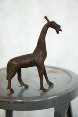 A side profile of the vintage copper giraffe, detailing its etched circular patterns.