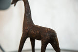 Textured copper finish and raised circular spot pattern on a vintage giraffe figure.