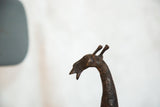 Profile view of the sculpted copper head of a vintage African giraffe.