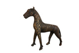 Vintage African copper zebra sculpture with textured gold striped pattern.