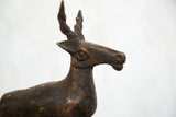 Textured copper head of the vintage African antelope sculpture with twisted horns.