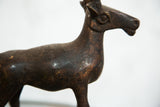Vintage African copper antelope sculpture with detailed head and aged, dark patina.
