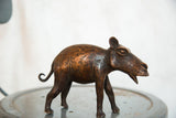 Vintage African copper hippo sculpture showcasing its mottled patina and detailed side profile.