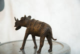 Textured back and tail of vintage African copper rhino sculpture.