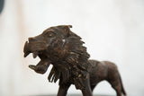 Vintage African lion copper sculpture head with open mouth and textured mane details.