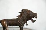 Vintage African copper lion head, showing detailed mane and open mouth.