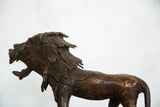 Vintage copper African lion sculpture with a textured mane and open mouth.