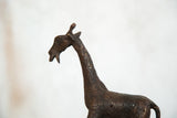Detailed texture and circular patterns on the vintage copper giraffe sculpture's neck.