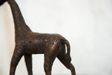 Dark copper giraffe sculpture back with embossed circular patterns and curved tail.