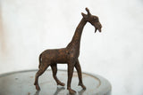 Detailed vintage African copper giraffe sculpture with textured patterns and open mouth.
