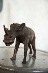 Vintage African rhino sculpture with dark copper patina and detailed face.