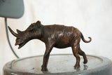 Textured copper lower body and distinct curled tail of the vintage African rhino.